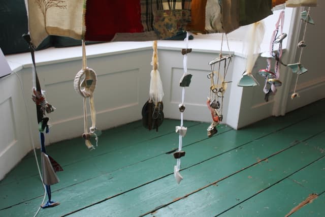 found materials strung on material as wind chimes